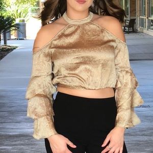 Gold cold shoulder top with tie accent in back.